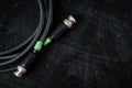 Black cable for transferring sdi signal through bnc connector on a dark background