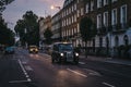 Black cabs with illuminated taxi signs on a street in London, UK. Royalty Free Stock Photo