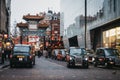 Black cabs parked at the taxi ranks in front of the entrance to China Town, Piccadilly Circus, London, UK