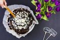 Black cake on black background with flowers