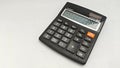 Black Calculator with Orange Function Button on White. Royalty Free Stock Photo