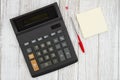 Black calculator with sticky note pad and pen on desk Royalty Free Stock Photo