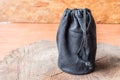 Black camera lens bag on wood Royalty Free Stock Photo