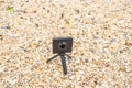 360 degree camera on sea shore stone.