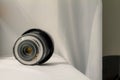 Black camera zoom lens on white cloth Royalty Free Stock Photo