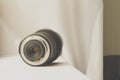 Black camera zoom lens on white cloth Royalty Free Stock Photo