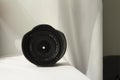 Black camera zoom lens on white cloth Royalty Free Stock Photo