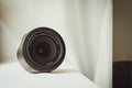 Black camera zoom lens on white cloth Royalty Free Stock Photo