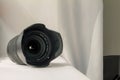 Black camera zoom lens on white cloth Royalty Free Stock Photo