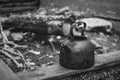 Black camping kettle stands on benches in the forest