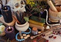 Black candles, magic wands and witch pot with herb on altar table Royalty Free Stock Photo