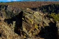 Enormous moss-rock boulder on the top edge of Black Canyon of the Gunnison National Park in Colorado Royalty Free Stock Photo