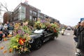 A Black car decorated with vibrant flowers at the Flower Parade Bollenstreek Royalty Free Stock Photo