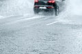 Black car driving in high speed making water splashes Royalty Free Stock Photo