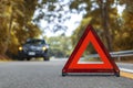 Black car have accident park on road. Red triangle, red emergency stop sign, red emergency symbol and black car stop and park on