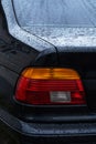 black car in the yard in water drops after rain with Royalty Free Stock Photo