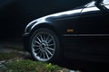 black car in the yard in water drops after rain with Royalty Free Stock Photo