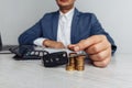 Black car key with contract on wooden table and man with money. Concept business finance and insurance, savings plans Royalty Free Stock Photo