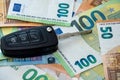 black car key lie on euro money as background, auto insurance Royalty Free Stock Photo