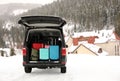 Car with luggage in trunk on snowy road. Winter vacation Royalty Free Stock Photo