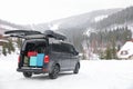 Car with luggage in trunk on snowy road. Winter vacation Royalty Free Stock Photo