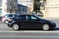 Black car Mazda3 Second generation BL driving on the street. Rushing vehicle on the urban road with motion blurred background