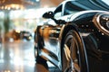 Black car parked in luxury showroom. Closeup new car parked in modern showroom. Automobile leasing and insurance background.