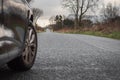 Black car parked on a small straight country road. Royalty Free Stock Photo