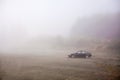 Black car parked on top of a mountain during heavy fog Royalty Free Stock Photo