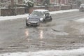 Black car rides on big puddle in snowy day. Sleet splash on a Manchester's road.03/03/2016 Manchester, England editoria Royalty Free Stock Photo