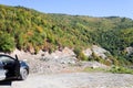 A black car stands at a halt on the road to Mestia. Wooded mountains. Royalty Free Stock Photo