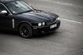 Black car on the street. Front of the Jaguar XJ up close. Riga, Latvia - 28 Apr 2022 Royalty Free Stock Photo