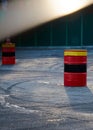 Black car tire skid track on asphalt road track. Tin barrels of red, black, yellow color