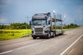 Black car transporter on a road with power station on the background Royalty Free Stock Photo