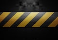 Black carbon fiber textured material design with warning tape in Royalty Free Stock Photo