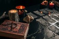 Black cards with magic signs laid out on a dark table. Halloween