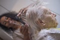 Black girl cuts hair to old white woman