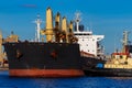 Black cargo ship mooring at the port