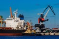 Black cargo ship mooring at the port