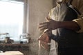 Black Carpenter Brushing Sawdust Off of Hands with Cloud in Air Royalty Free Stock Photo