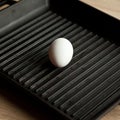 Black cast heavy iron grill pan in organic white eggs on modern oak kitchen countertop