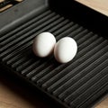 Black cast heavy iron grill pan in two organic white eggs on modern oak kitchen countertop