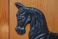 Black cast iron horse head. Door stop. Pine door.