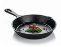 Black Cast Iron Skillet with Cherry Tomatoes Basil and Pepper on White Background Royalty Free Stock Photo