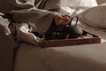 Black cast iron tea pot with herbal tea set up on wood tray on the bed. Royalty Free Stock Photo