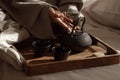 Black cast iron tea pot with herbal tea set up on wood tray on the bed. Royalty Free Stock Photo