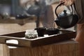 Black cast iron tea pot with herbal tea set up on wood tray. Traditional Asian Tea Set Royalty Free Stock Photo