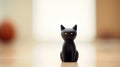 A black cat figurine sitting on a table, AI Royalty Free Stock Photo