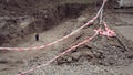 Pit dug protective red tape