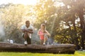 Black Caucasian couple stretching after exercise on tree trunk